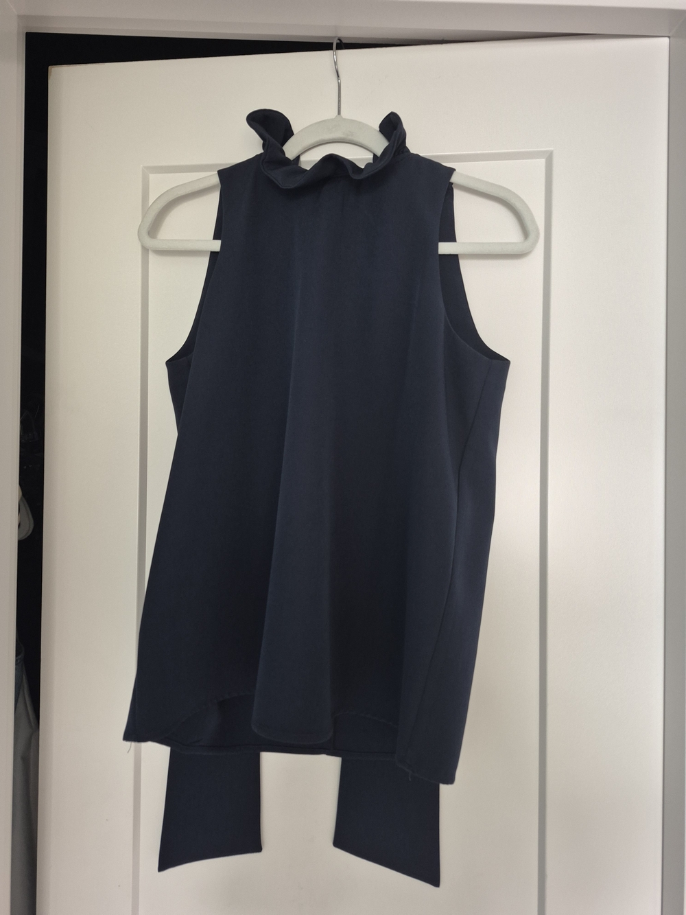 Tuckernuck Navy Ruffle Mock Neck Sleeveless Top With Tie Neck